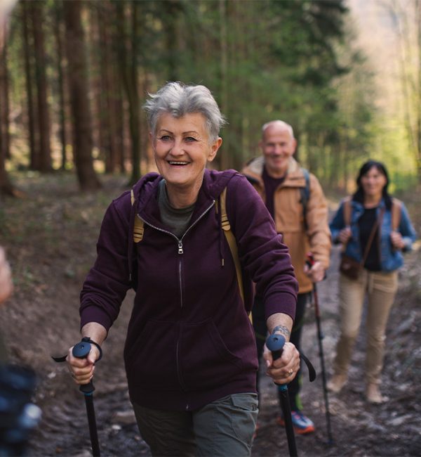senior woman smiling while hiking with friends safest place for retirement money sparta tn